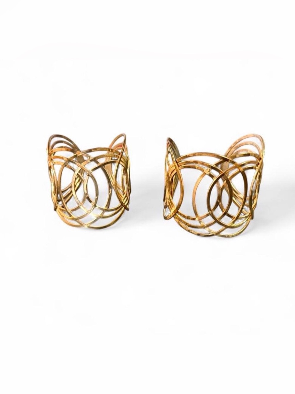 Gold metal cuff bracelet with interlocking circular design
